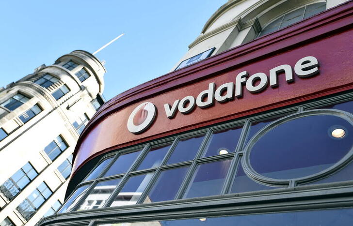 FILE PHOTO: Branding for Vodafone is seen on the exterior of a shop in London, Britain, September 10, 2015. REUTERS/Toby Melville/File Photo