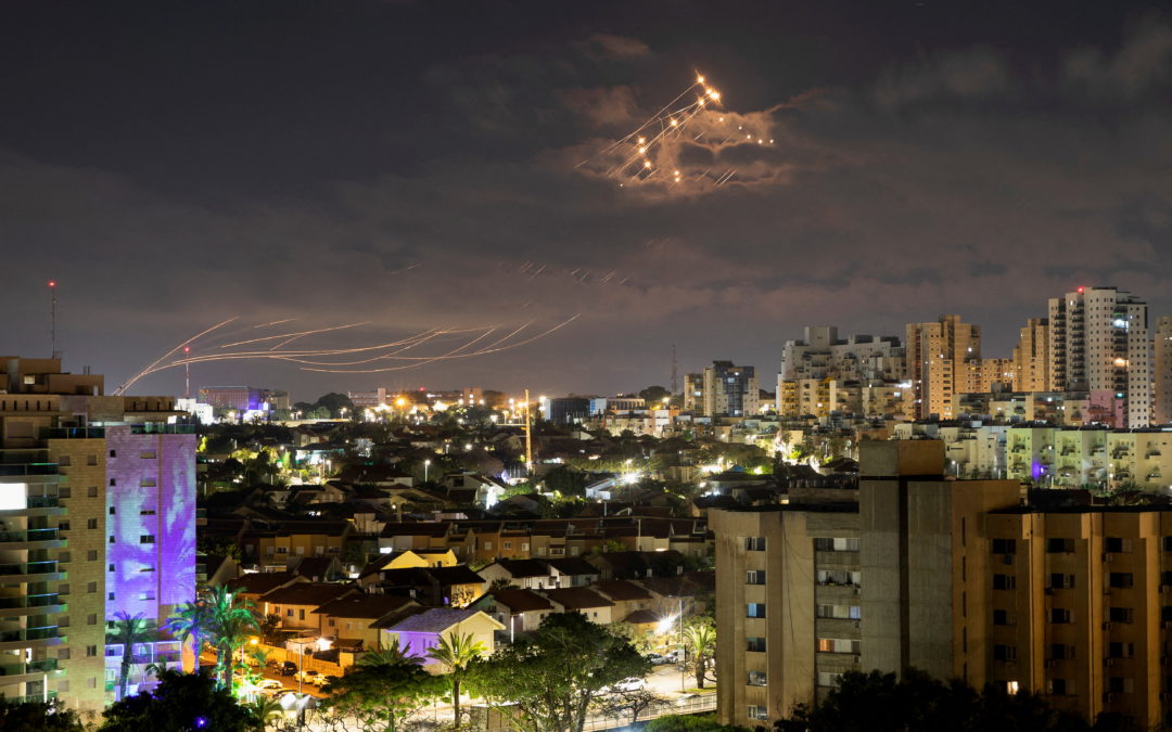 Streaks of light are seen as Israel’s Iron Dome anti-missile system intercepts rockets launched from the Gaza Strip towards Israel