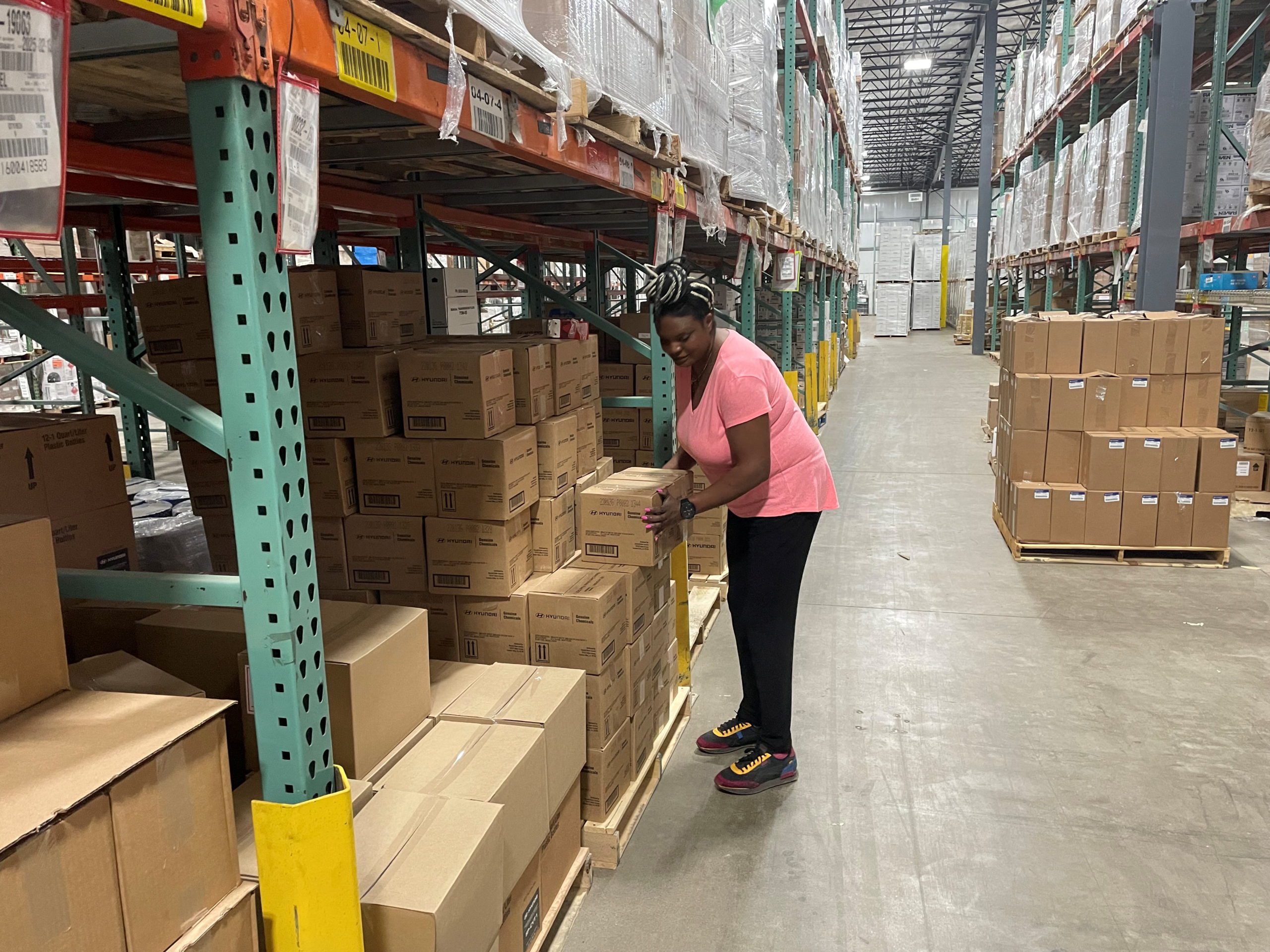 Sheila Ikenye picks boxes for a shipment at Kem Krest's warehouse in Elkhart, Indiana, U.S. March 24, 2022. REUTERS/Timothy Aeppel