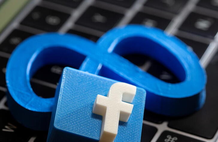 A 3D printed Facebook's new rebrand logo Meta and Facebook logo are placed on laptop keyboard in this illustration taken on November 2, 2021. REUTERS/Dado Ruvic/Illustration