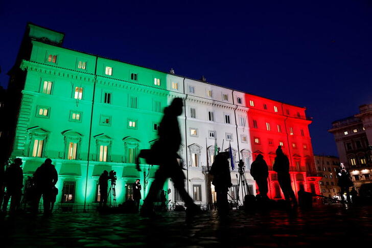 FILE PHOTO: Rome's Palazzo Chigi, the seat of the Italian government, is lit up with the colours of the Italian flag on Jan. 15, 2021. REUTERS/Remo Casilli//File Photo