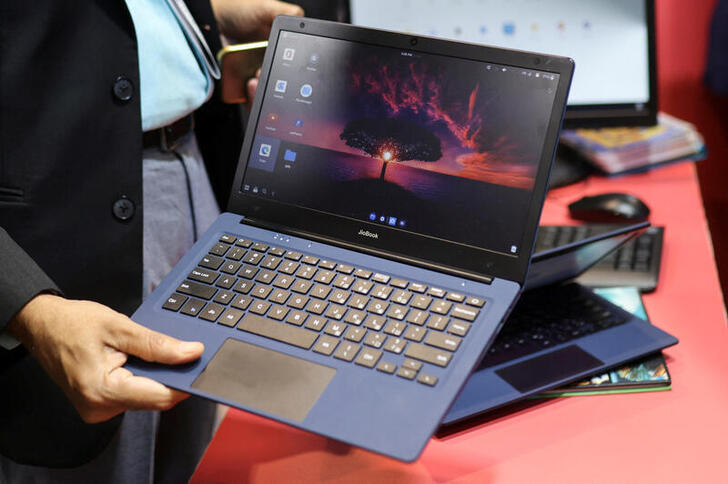 A man holds the Reliance's soon to be launched laptop called JioBook, kept on display at a stall of Jio at the ongoing India Mobile Congress 2022, at Pragati Maidan, in New Delhi, India, October 3, 2022. REUTERS/Anushree Fadnavis