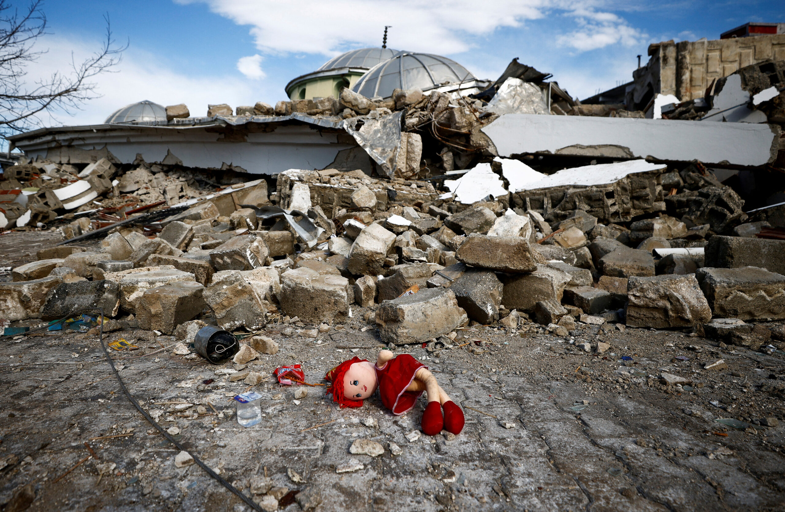 A doll lies on the ground near the site of a collapsed mosque, following an earthquake in Hatay, Turkey February 7, 2023. REUTERS/Guglielmo Mangiapane