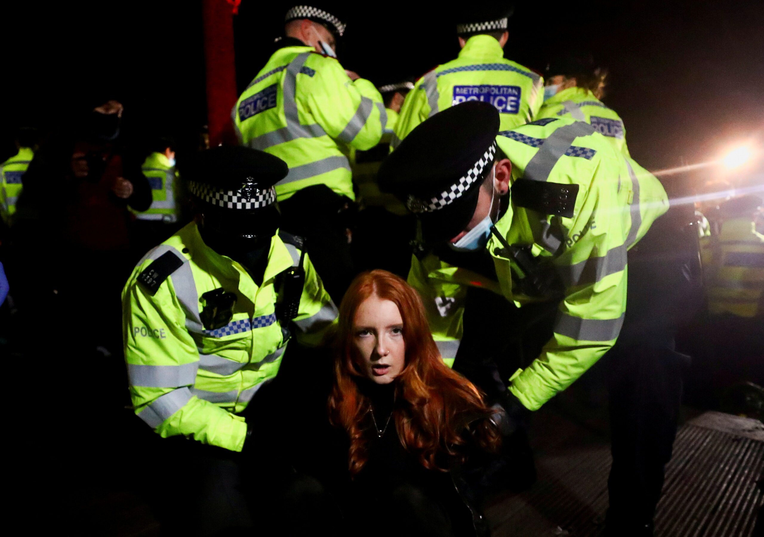 Police detain a woman as people gather at a memorial site in Clapham Common Bandstand, following the kidnap and murder of Sarah Everard, in London, Britain March 13, 2021. REUTERS/Hannah McKay/File Photo     TPX IMAGES OF THE DAY SEARCH 