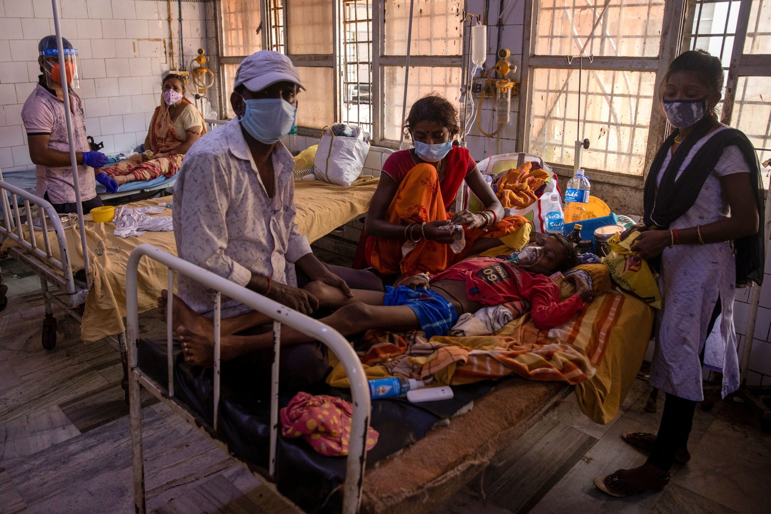 A patient suffering from diabetes lies on a hospital bed as his family look after him on the emergency ward of Jawahar Lal Nehru Medical College and Hospital, during the coronavirus disease (COVID-19) outbreak, in Bhagalpur, Bihar, India, July 26, 2020. REUTERS/Danish Siddiqui