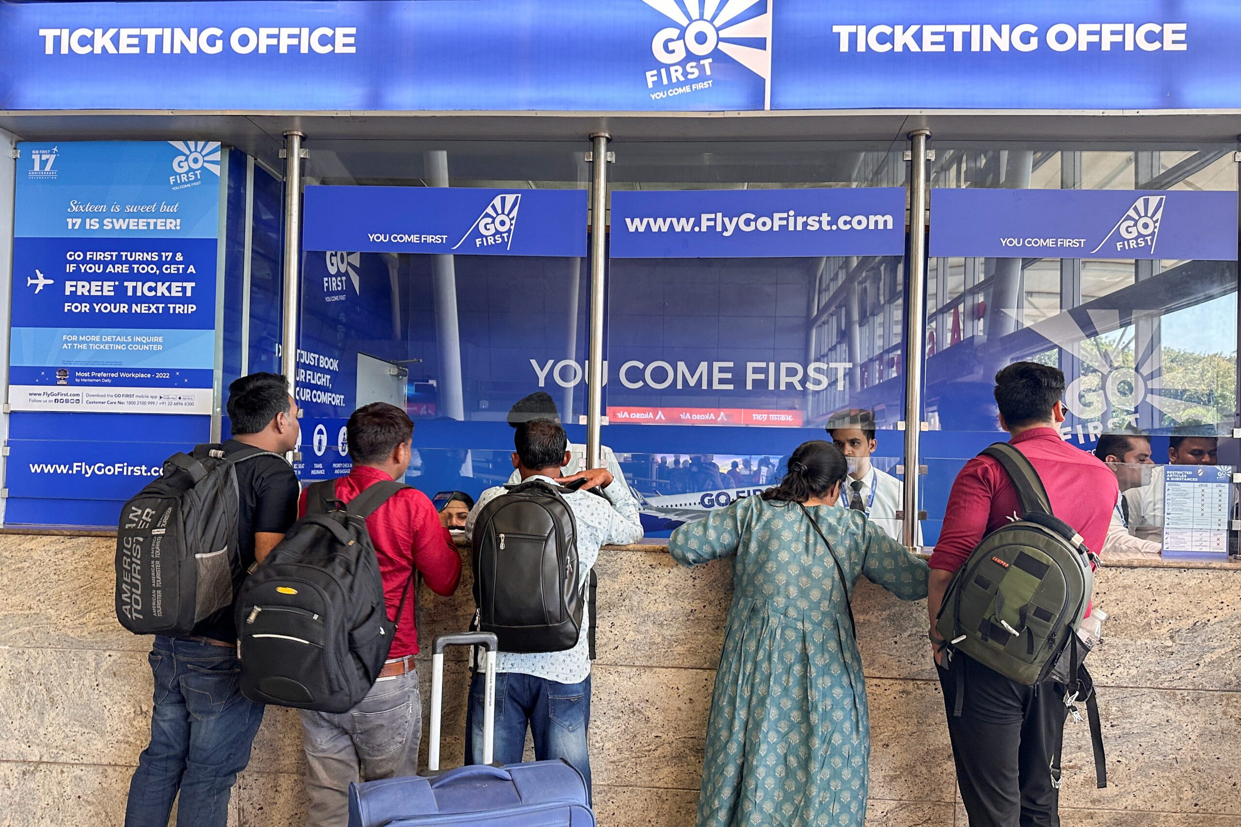 People wait to claim refunds after their flights were cancelled, from the Go First airline ticketing counter at the Chhatrapati Shivaji International Airport in Mumbai, India, May 3, 2023. REUTERS/Francis Mascarenhas