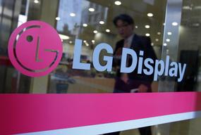 A man walks out of the headquarters of LG Display in Seoul, October 20, 2011. South Korean flat-screen maker LG Display, a key supplier to Apple Inc, posted a wider-than-expected quarterly loss on Thursday as tepid demand for TVs and PCs hit panel prices and one-off losses weighed. REUTERS/Jo Yong-Hak (SOUTH KOREA - Tags: BUSINESS)