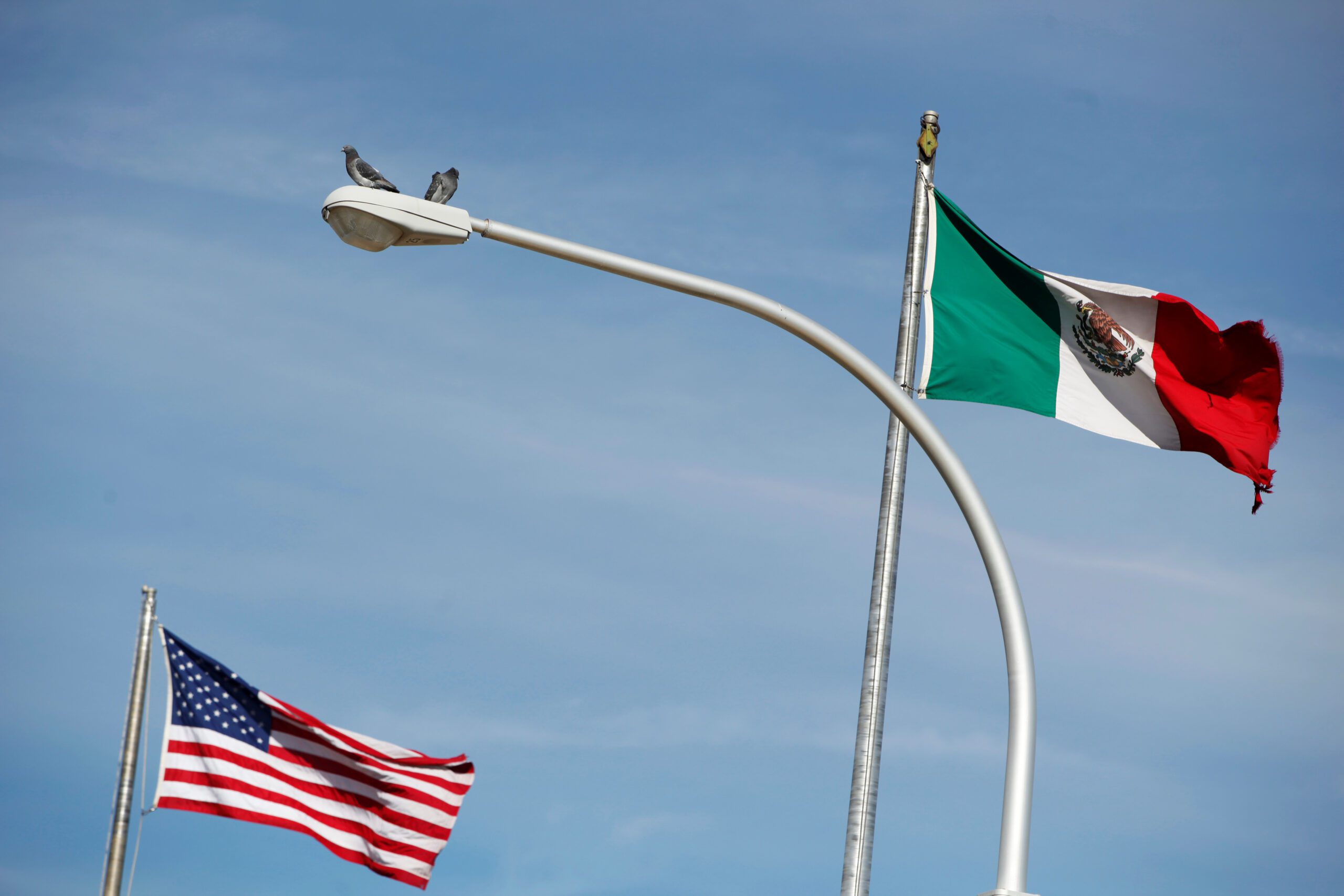 FILE PHOTO: The US flag (L), and the Mexico's flag are pictured on the international border bridge Paso del Norte in between El Paso US and Ciudad Juarez in Ciudad Juarez, Mexico December 28, 2016. Picture taken on December 28, 2016. REUTERS/Jose Luis Gonzalez/File Photo
