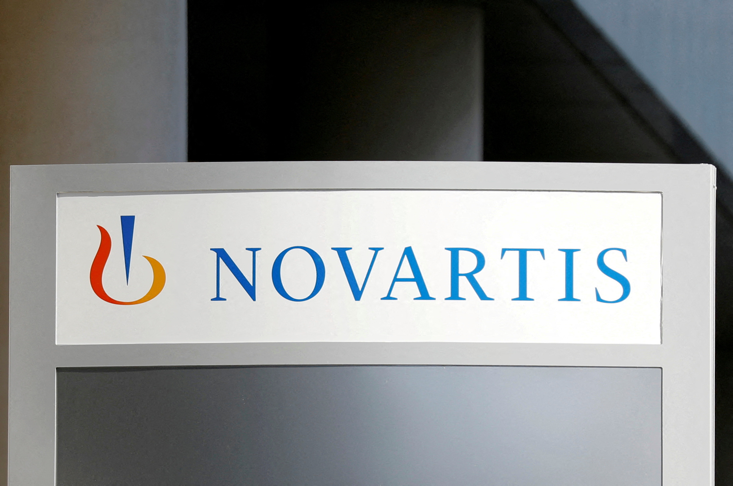 FILE PHOTO: The logo of Swiss drugmaker Novartis is pictured at the company's French headquarters in Rueil-Malmaison near Paris, France, April 22, 2020. REUTERS/Charles Platiau/File Photo