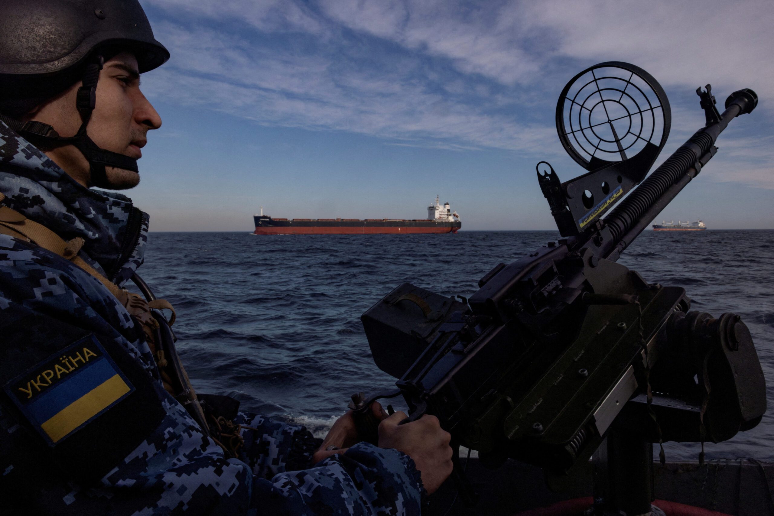 FILE PHOTO: A serviceman of Ukraine's coast guard mans a gun on a patrol boat as a cargo ship passes by in the Black Sea, amid Russia’s attack on Ukraine, February 7, 2024. REUTERS/Thomas Peter/File Photo