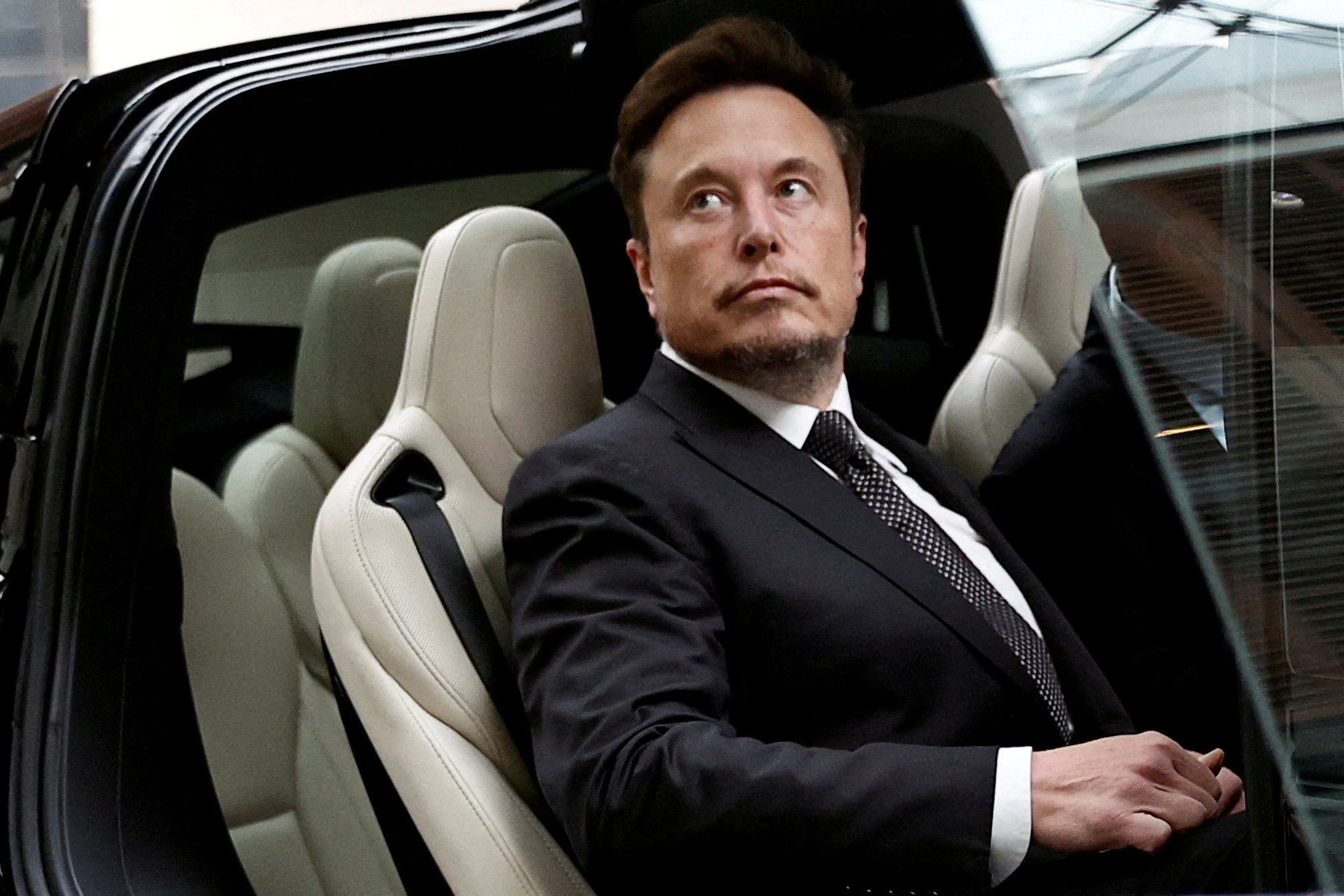 Elon Musk gets in a Tesla car as he leaves a hotel in Beijing, May 31, 2023. REUTERS/Tingshu Wang