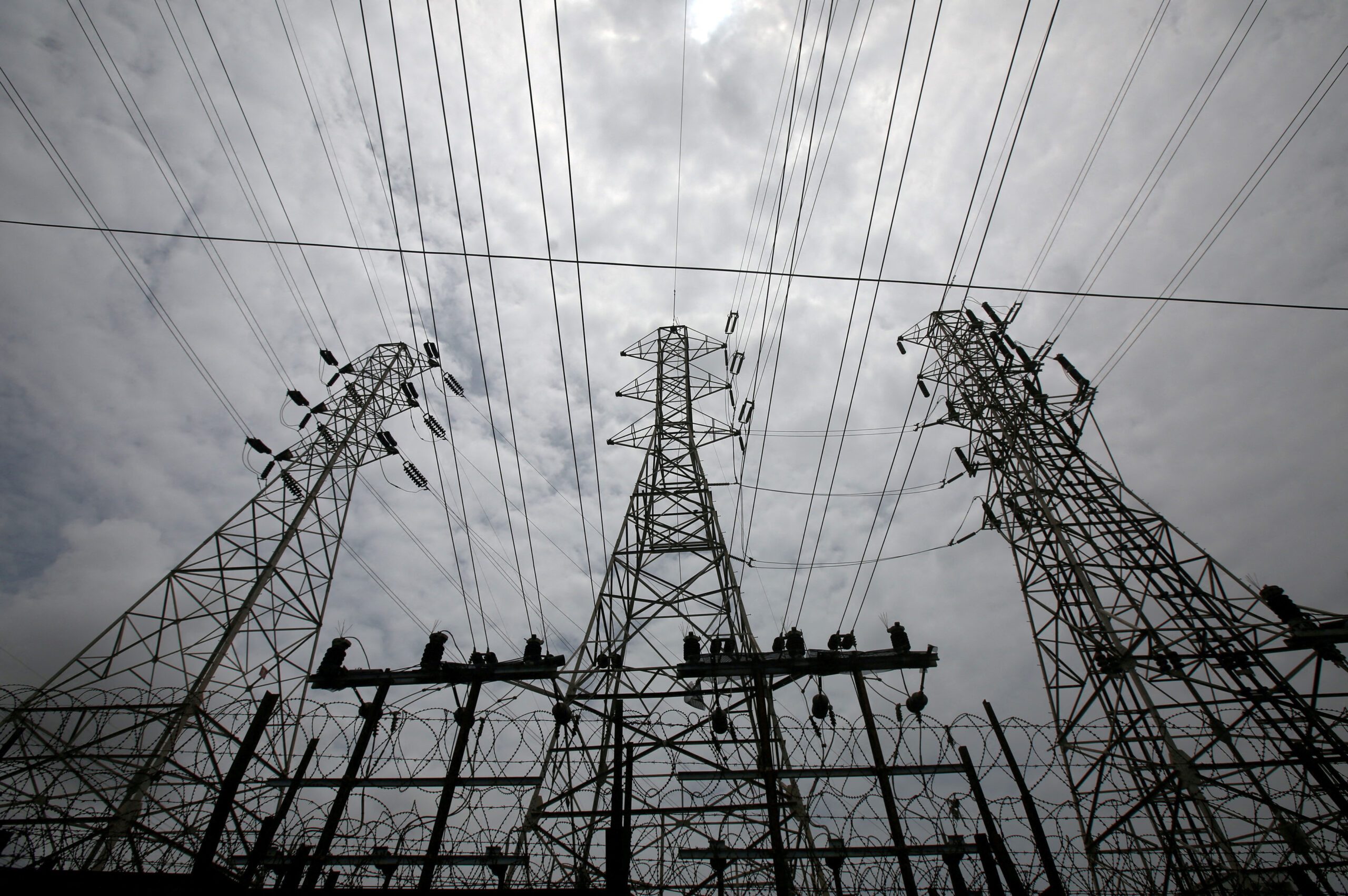 FILE PHOTO: High-tension power lines are pictured outside a Tata Power sub station in the suburbs of Mumbai, India, August 8, 2017. REUTERS/Shailesh Andrade/File Photo