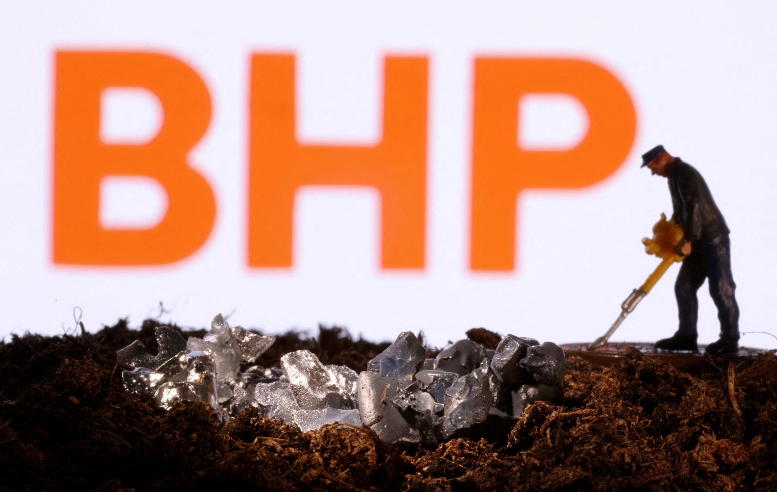 FILE PHOTO: A small toy figure and mineral imitation are seen in front of the BHP logo in this illustration taken November 19, 2021. REUTERS/Dado Ruvic/Illustration/File Photo/File Photo
